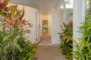 a hallway with plants in a house at Tropical Resort-style Living on Mirage Golf Course in Port Douglas