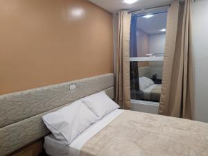 Postel nebo postele na pokoji v ubytování D' Loft Iligan