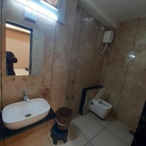 a bathroom with a sink and a toilet at Hotel Purushottam in Dwarka