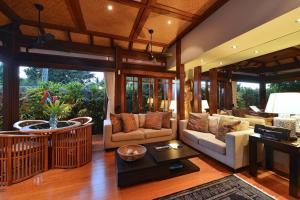a living room with a couch and a table at Paradiso Pavilion - An Intimate Bali-style Haven in Port Douglas