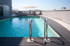 a swimming pool on top of a building at Hotel Barcelona Condal Mar Affiliated by Meliá in Barcelona