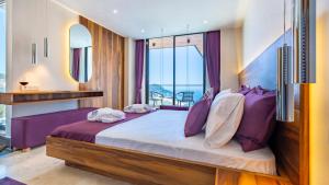 a bedroom with a large bed with purple pillows at Villa Phi with heated indoor pool in Kas +32 photos