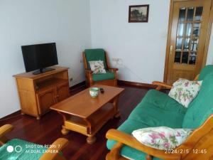 a living room with a couch and chairs and a table at Apartamento calle Sainza 2 in Ourense
