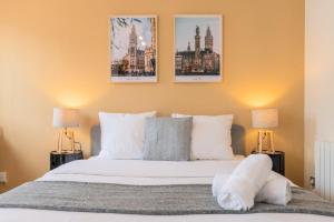 a bedroom with a bed with three pictures on the wall at Lille Hypercentre equipped studio for 2 people! in Lille