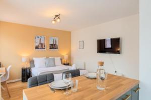 a room with a bed and a table with glasses on it at Lille Hypercentre equipped studio for 2 people! in Lille