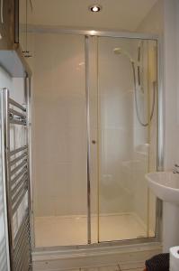 a shower with a glass door in a bathroom at Ty Pen y Bryn in Dolgellau in Dolgellau +40 photos