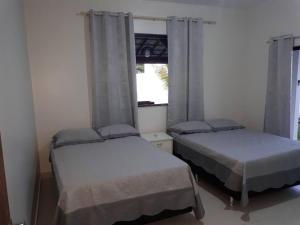 2 camas en una habitación con ventana en Casa de Excelente Padrão, COND. ÁGUAS DE OLIVENÇA en Olivença
