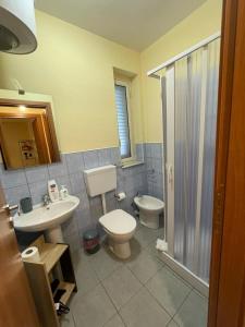 a bathroom with a toilet and a sink and a shower at Villa Theía apartaments sul mare in Montallegro +54 photos