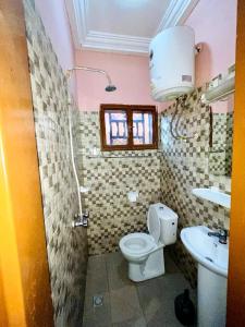 a bathroom with a toilet and a sink at As résidence meublée in Ouagadougou