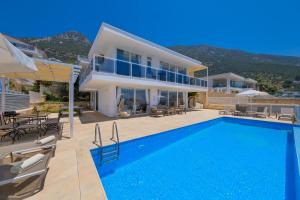 a villa with a swimming pool and a house at Lumiere Villas 2 in Kalkan