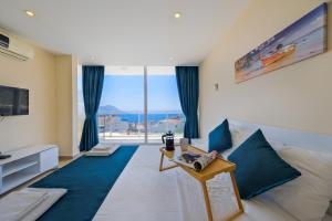 a living room with a bed and a large window at Lumiere Villas 2 in Kalkan