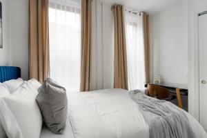 a bedroom with a white bed and a window at 91-2A Stylish 3BR 2Bth with W D in New York