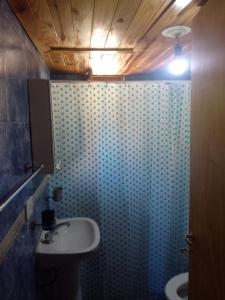 a bathroom with a sink and a toilet at CABAÑAS EL PALENQUE in Esquel +32 photos