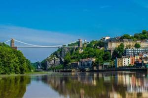 a bridge over a river with buildings and a city at Green Glades Annex by StayStaycations in Bristol