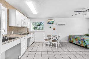 a kitchen with a table and a bed in a room at Blackfin Resort and Marina in Marathon