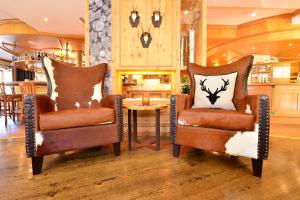 twee stoelen en een tafel in een kamer bij Hotel Jagdhof in Riezlern