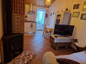 a living room with a fireplace and a stove at Casa Alentejana in São Teotónio