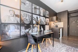 a dining room with a black table and chairs at Studio located on the Grand Place! in Lille