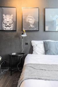 a bedroom with three pictures of tigers on the wall at Studio located on the Grand Place! in Lille