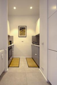 a kitchen with two mats on the floor at Attic with terrace on Conca d'oro in Rome