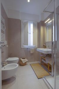 a bathroom with a tub and a sink and a mirror at Attic with terrace on Conca d'oro in Rome