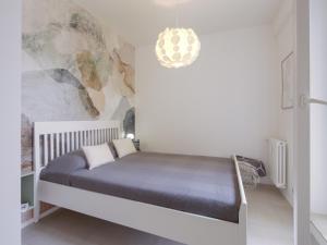a bedroom with a bed in a white room at Attic with terrace on Conca d'oro in Rome