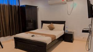 a bedroom with a bed and a air conditioner at THE METRO INTERNATIONAL HOTEL in Hyderabad