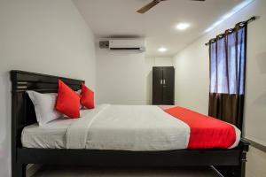 a bedroom with a large bed with red pillows at THE METRO INTERNATIONAL HOTEL in Hyderabad