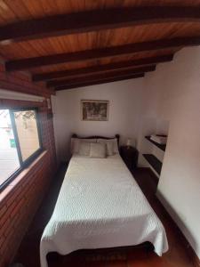 a bedroom with a white bed in a room at Real Dream Hostel in San Gil