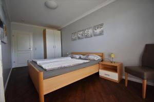 キュールングスボルンにあるUrlaubstraeume-Am-Meer-Wohnung-6-2-758のベッドルーム(大型ベッド1台、椅子付)
