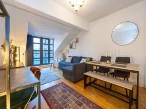 a living room with a table and a couch at Pass the Keys MCR City Centre Apartment with view in Manchester