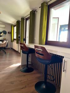 a bar with two chairs at a counter in a room at ZEN Apartments in Alexandroupoli