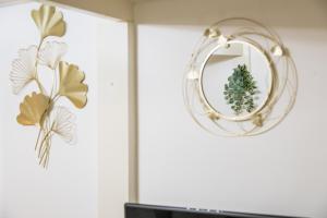 a mirror on a wall with a christmas wreath at Martha's Studio in Budapest