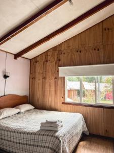 a bedroom with a bed and a window at Hospedaje Los Angeles in Futaleufú