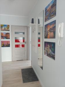 pasillo con paredes blancas, puertas blancas y espejo en Apartament KLARA, en Rumia