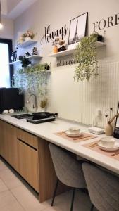 a kitchen with a counter with plates on it at Romantic Sea View Room @ Urban Suites, Jelutong in Jelutong