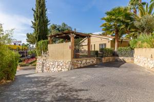 a house with a gate and a stone fence at Charming private villa in Marbella in Marbella