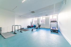 a gym with treadmills and exercise equipment in a room at Montempô + Apparthôtel Toulouse Cité Internationale in Toulouse