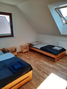 a bedroom with two beds in a attic at Słoneczna Polana nad Biebrzą in Goniadz