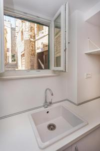 a white sink in a kitchen with a window at X Boutique Marinac Studio Apartments & Rooms in Šibenik +31 photos