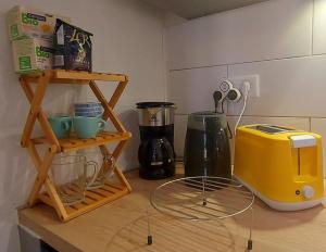 a kitchen counter with a yellow toaster and a blender at Zénith - Cartoucherie in Toulouse