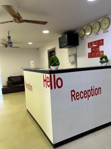 a hello reception counter in a room with clocks on the wall at THE METRO INTERNATIONAL HOTEL in Hyderabad