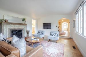 a living room with a couch and a fireplace at Avon Hills Quiet, 4B 1920s Tudor with Vintage Charms in Cincinnati