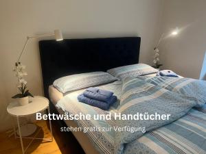 a bedroom with a bed with two towels on it at Wohnen im Herzen von Graz in Graz