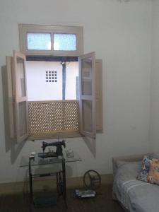 a room with a window and a sewing machine on a table at Casa Colonial. Centro Histórico in Paracatu