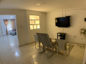 a living room with a table and chairs and a television at Apartamento Premium Cerca de Todo in Valledupar