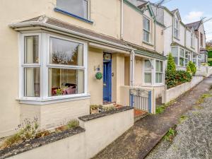 a house with a blue door on a street at 3 Bed in Barnstaple 77506 in Bishops Tawton