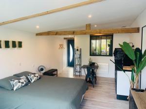 a bedroom with a bed and a living room at Chambre à la Noye in Estrées-sur-Noye