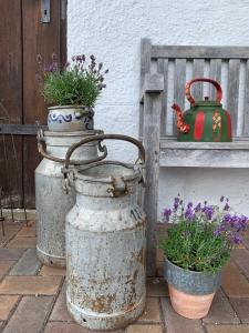 two flower pots sitting next to a bench at Der Gschwendtnerhof in Valley