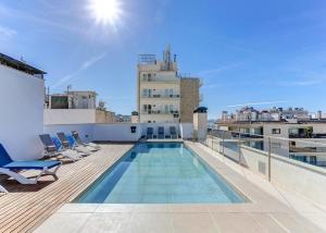 a swimming pool on the roof of a building at Apt Ca na Claire in Port de Pollensa